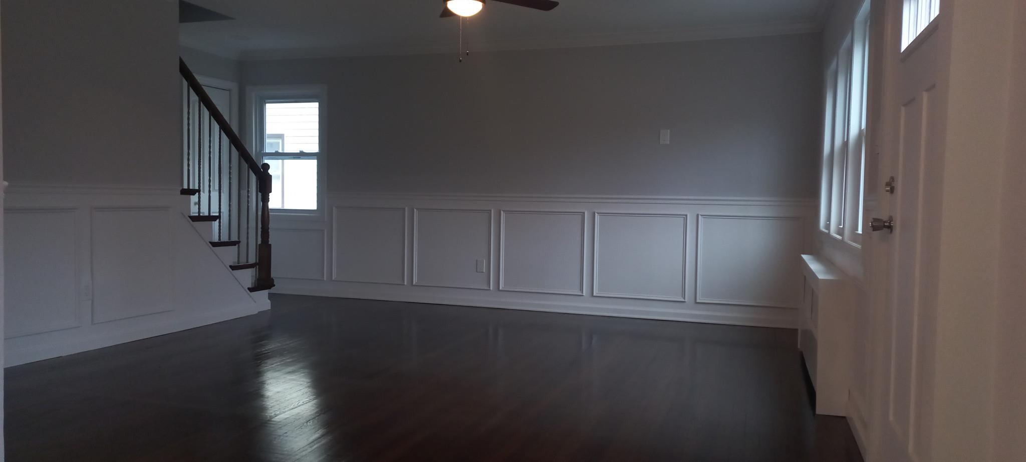 3 Hampton Road Lynbrook, NY 11563 - Photo 19 of 23 Foyer entrance with ornamental molding, ceiling fan, wainscoting, and stairs