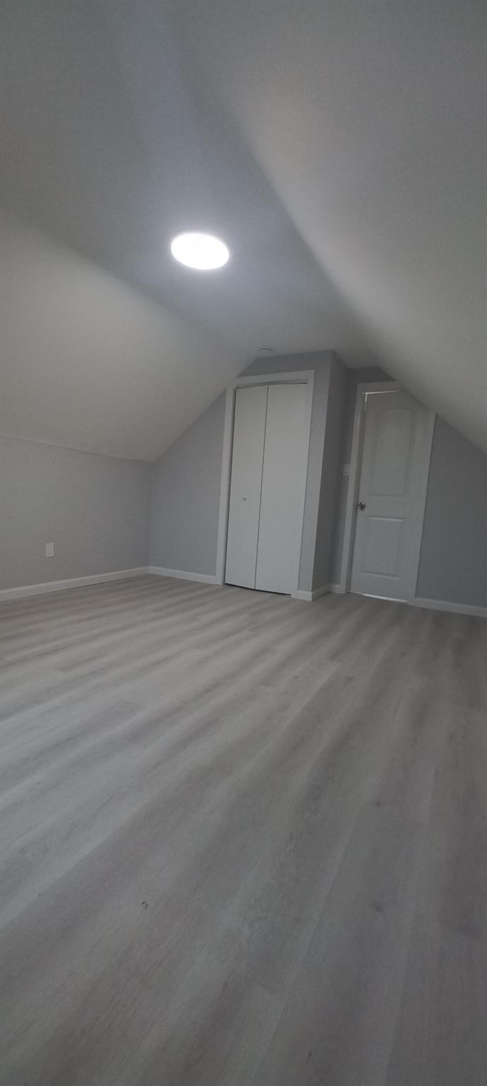 3 Hampton Road Lynbrook, NY 11563 - Photo 22 of 23 Additional living space featuring vaulted ceiling, light wood-type flooring, and baseboards