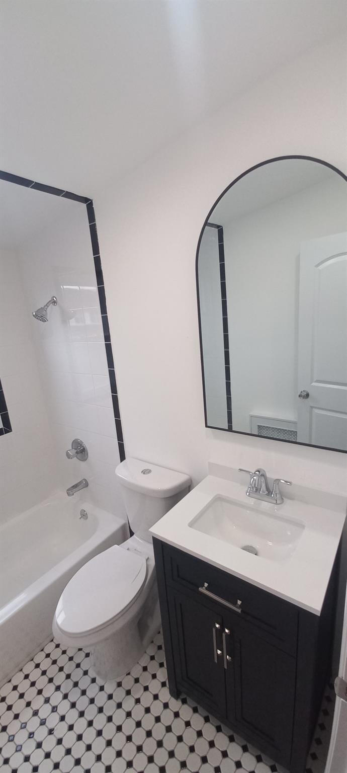 3 Hampton Road Lynbrook, NY 11563 - Photo 8 of 23 Bathroom with toilet, vanity, and shower / bathtub combination