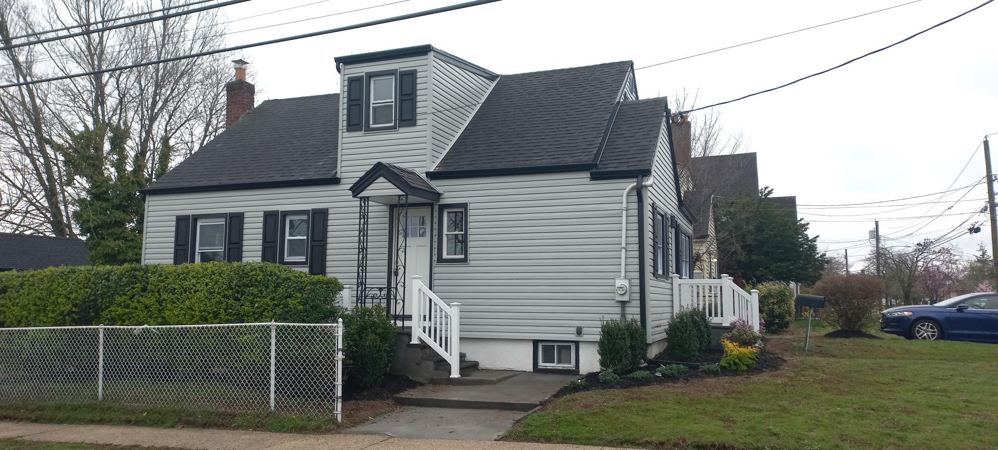 3 Hampton Road Lynbrook, NY 11563 - Photo 10 of 23 View of front of home featuring a chimney, a shingled roof, and a front lawn