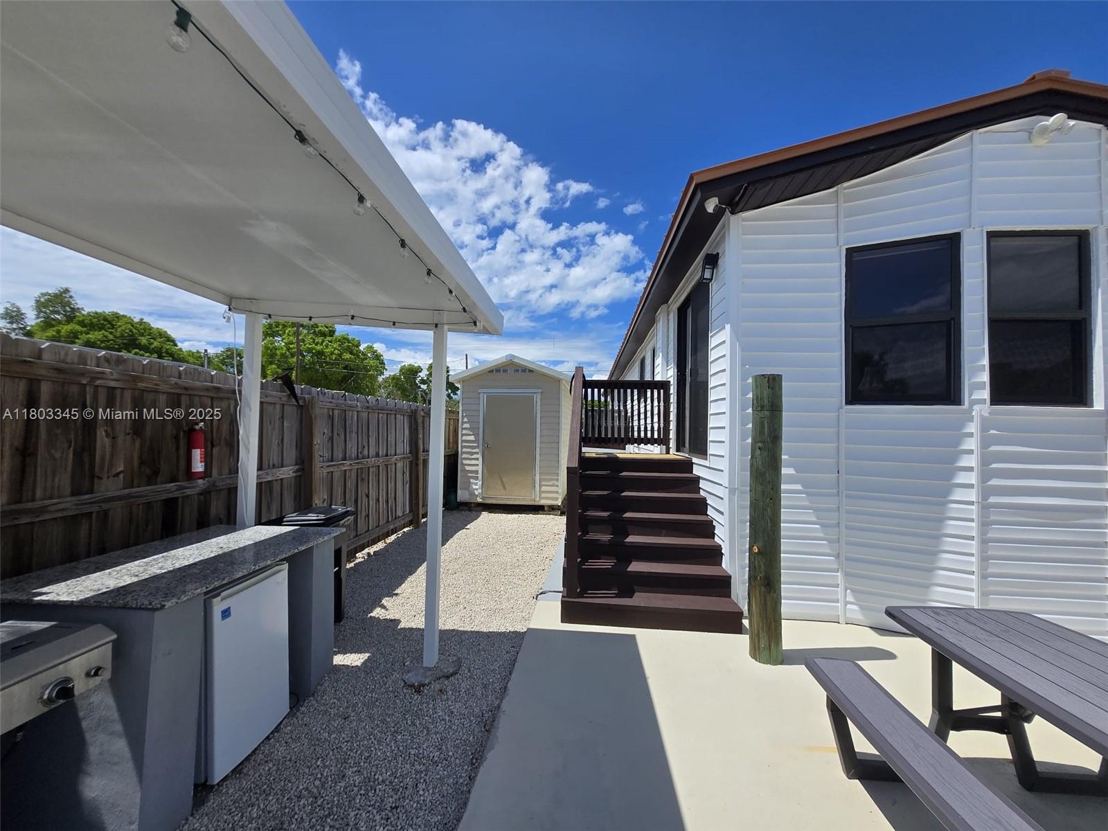 271 Lance Lane Key Largo, FL 33037 - Photo 16 of 33 a view of a porch with furniture and wooden floor