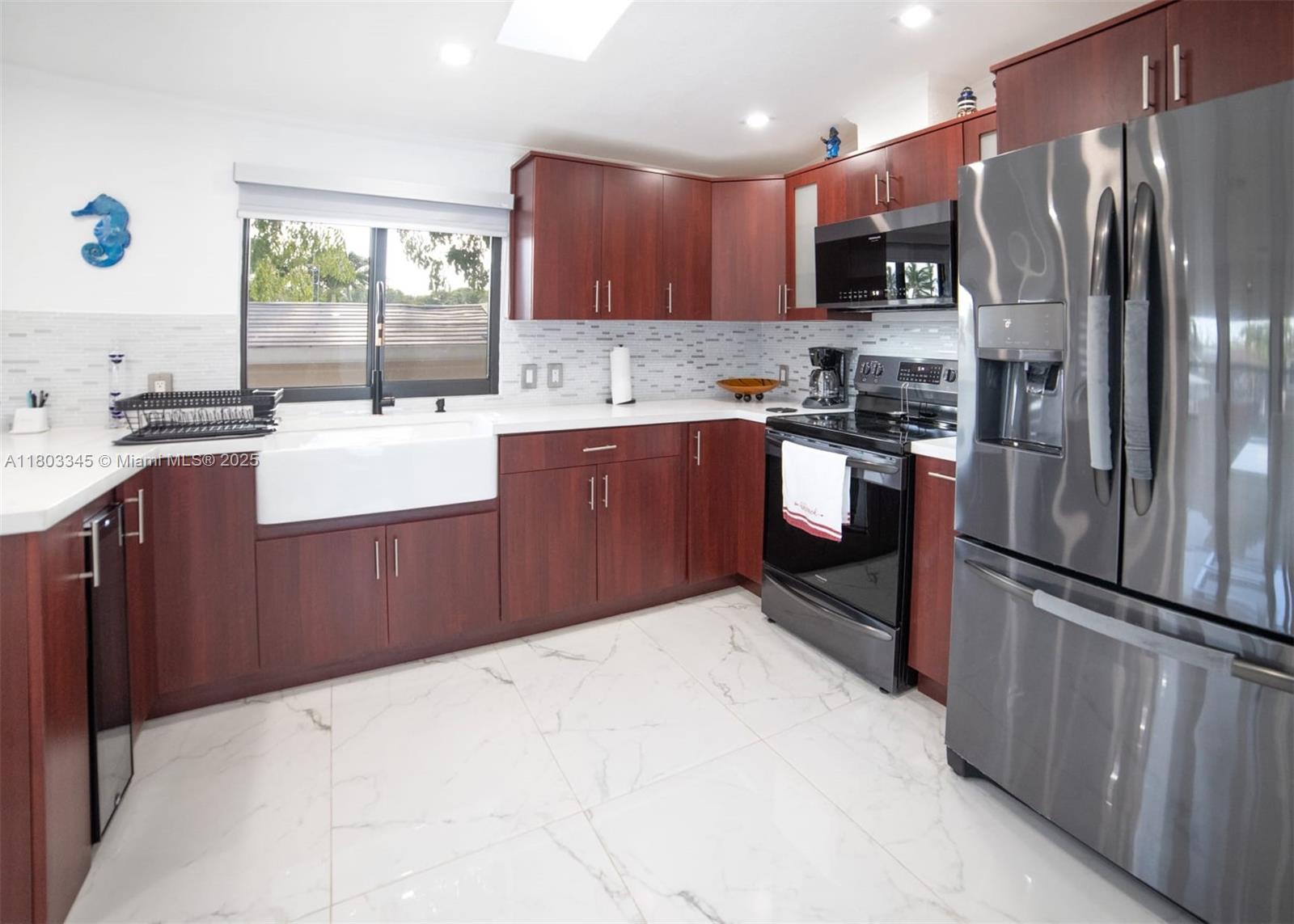 271 Lance Lane Key Largo, FL 33037 - Photo 23 of 33 a kitchen with stainless steel appliances granite countertop a refrigerator sink and wooden cabinets
