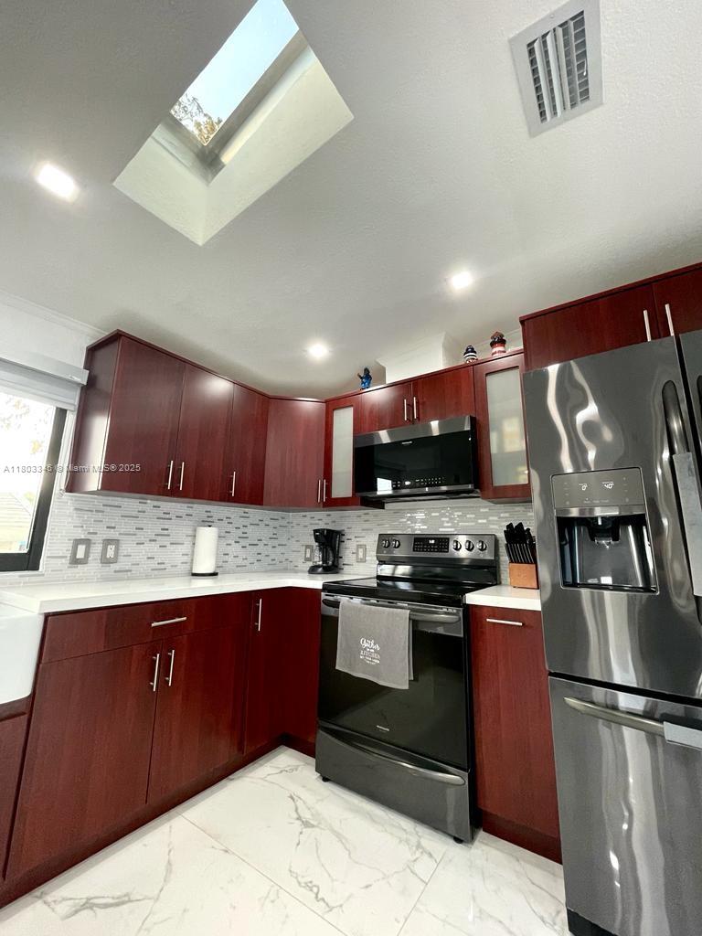 271 Lance Lane Key Largo, FL 33037 - Photo 24 of 33 a kitchen with stainless steel appliances granite countertop a stove a sink dishwasher and a refrigerator