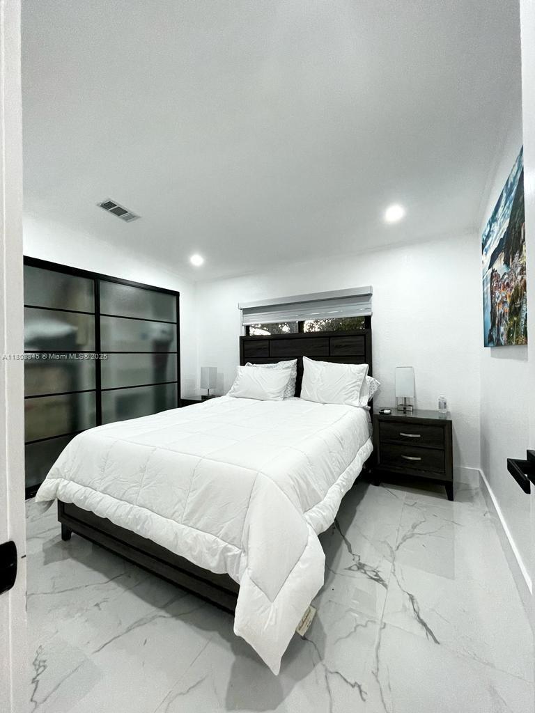 271 Lance Lane Key Largo, FL 33037 - Photo 26 of 33 a bedroom with a bed and a cabinets