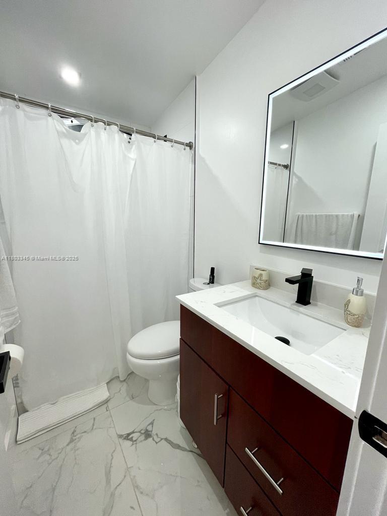 271 Lance Lane Key Largo, FL 33037 - Photo 28 of 33 a bathroom with a sink a toilet and shower