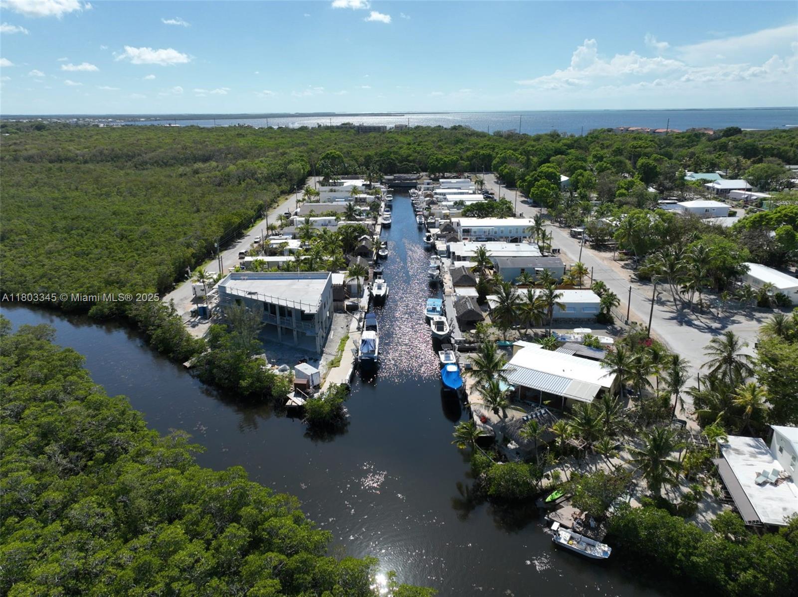 271 Lance Lane Key Largo, FL 33037 - Photo 3 of 33 an aerial view of a city with lots of residential buildings ocean and mountain view in back