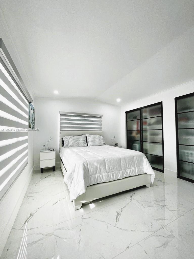 271 Lance Lane Key Largo, FL 33037 - Photo 31 of 33 a spacious bedroom with a bed and a view of walk in closet