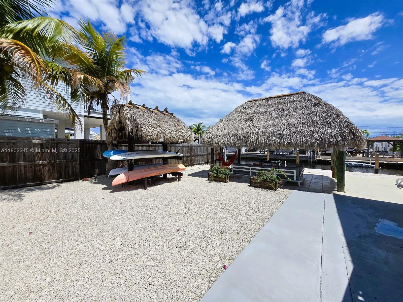 271 Lance Lane Key Largo, FL 33037 - Photo 9 of 33 a view of a terrace with a barbeque grill with a yard