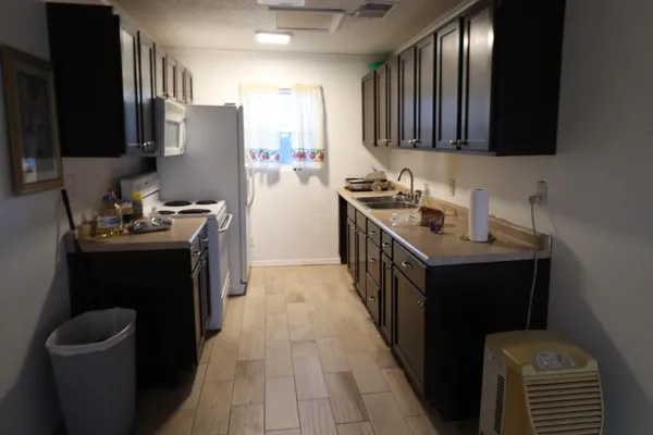 a kitchen with a sink appliances and cabinets