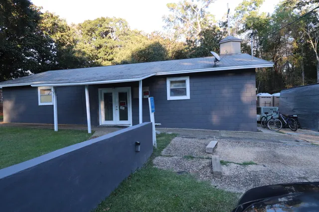 a view of backyard of house with outdoor seating and green space