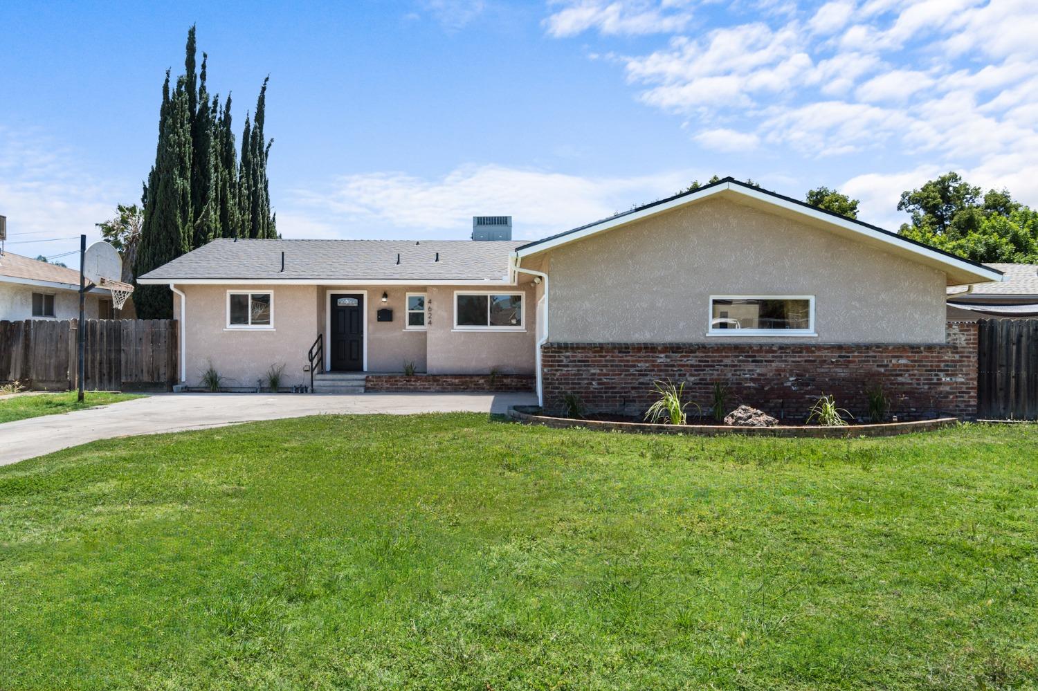 4624 East Cornell Avenue Fresno, CA 93703 - Photo 1 of 29 a front view of house with yard and green space