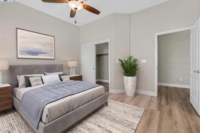 a bedroom with a large bed and a potted plant