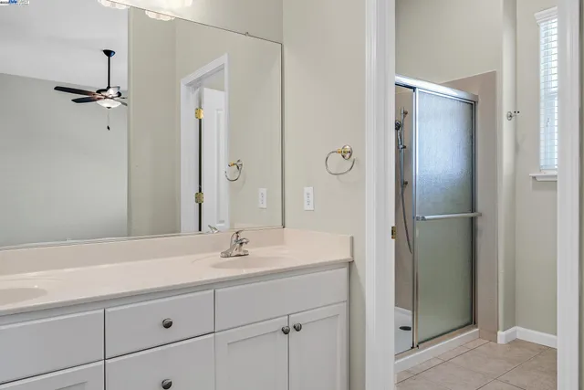 a bathroom with a shower sink and mirror