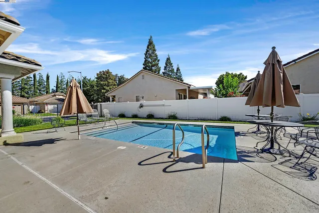 a view of playground with a patio