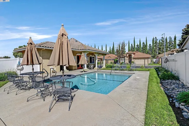 a view of yard with swimming pool and seating