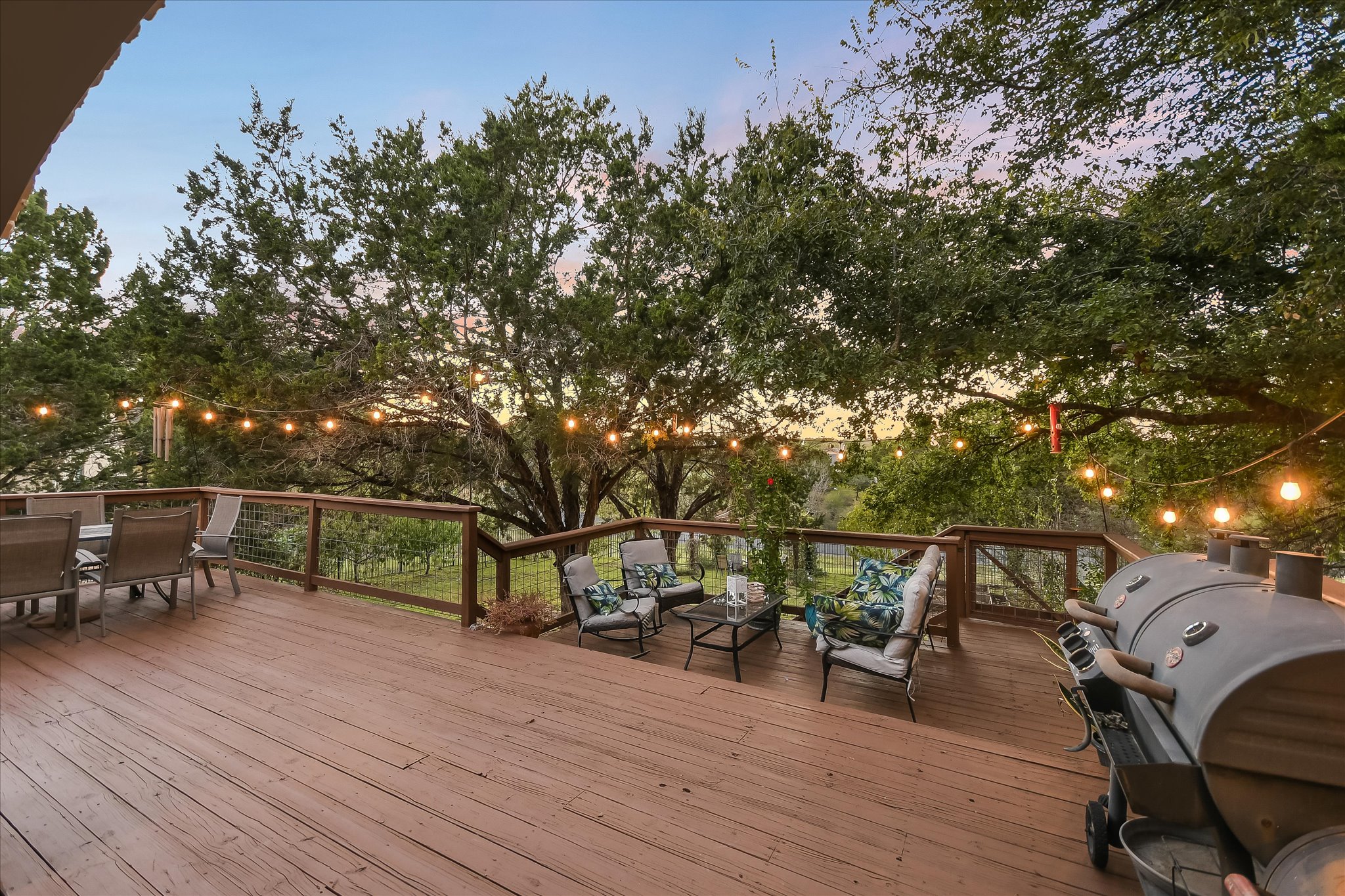 300 Wesley Ridge Drive Spicewood, TX 78669 - Photo 33 of 40 Step down to another outdoor seating area ... a seamless extension surrounded by lush greenery.