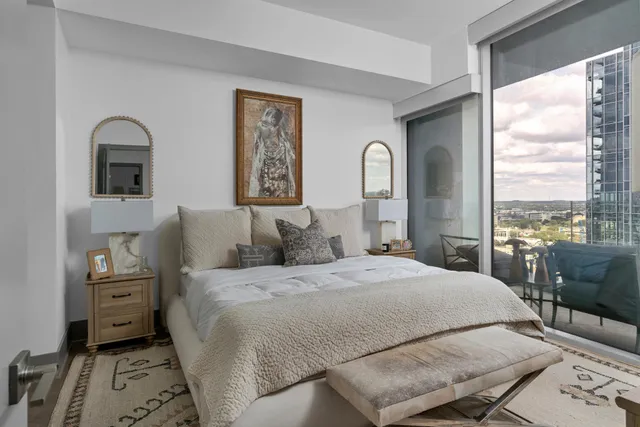 a bedroom with a bed and a large window