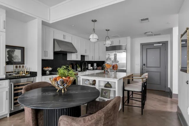 a kitchen with a dining table and chairs