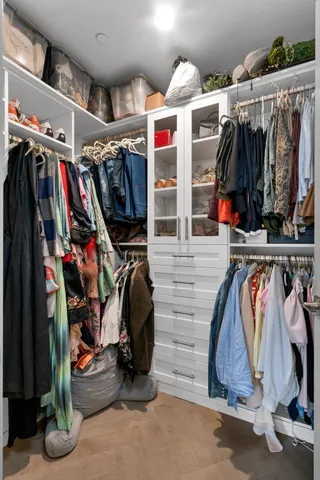 a view of walk in closet with clothes