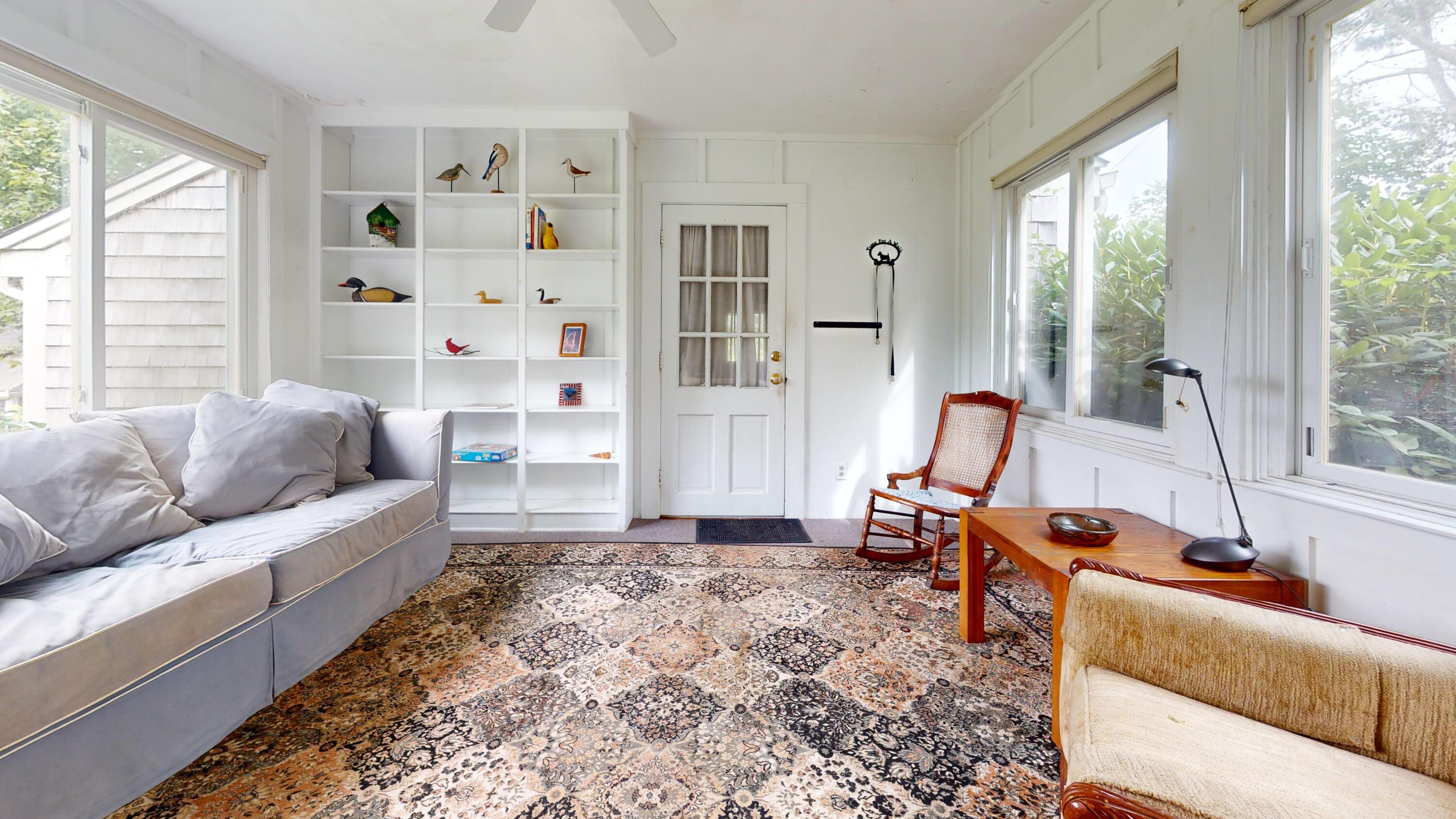 55 Monument View Road East Dennis, MA 02660 - Photo 11 of 40 a living room with furniture and a large window