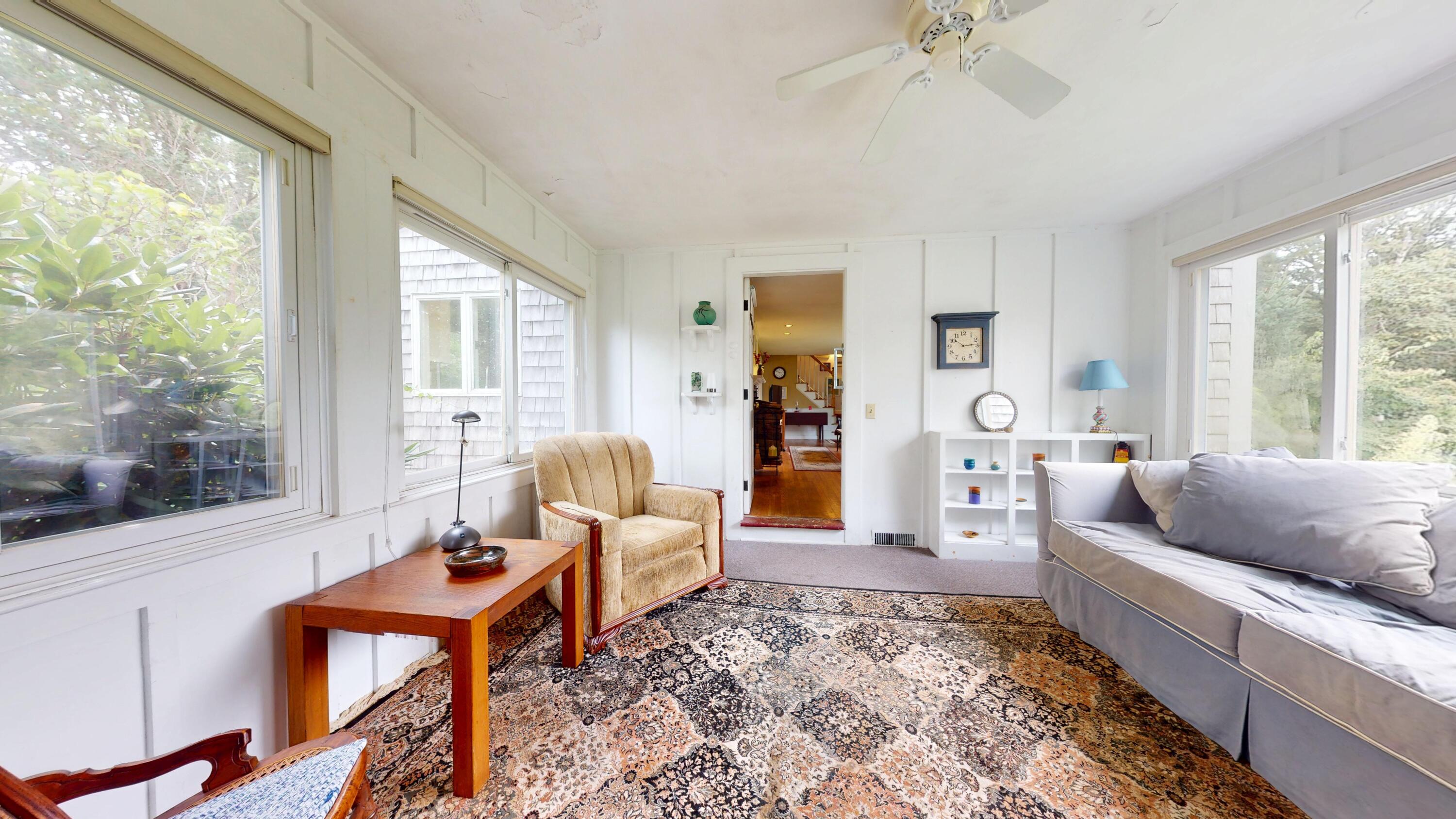 55 Monument View Road East Dennis, MA 02660 - Photo 12 of 40 a living room with furniture and a large window