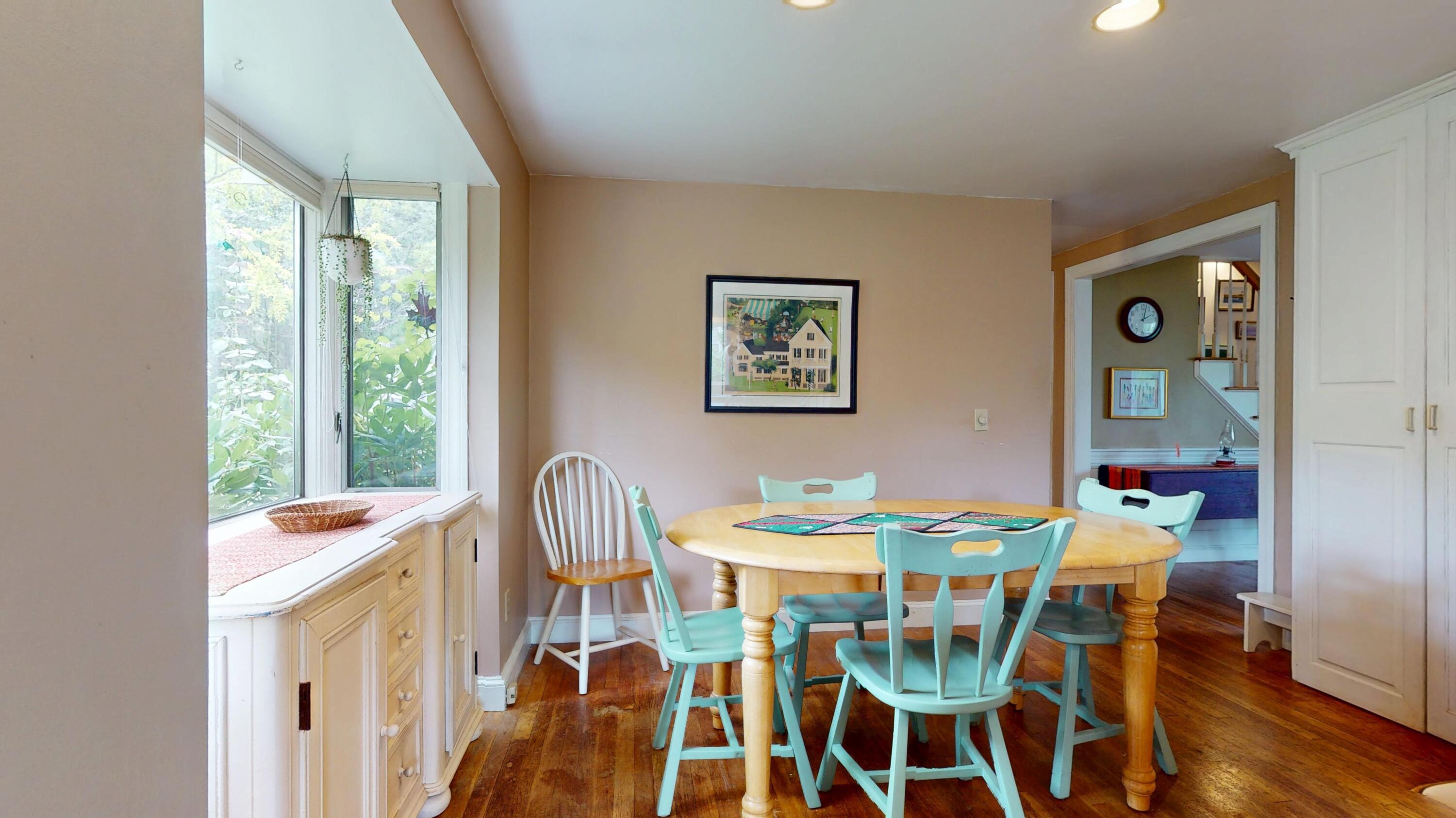 55 Monument View Road East Dennis, MA 02660 - Photo 15 of 40 a view of a dining room with furniture and wooden floor