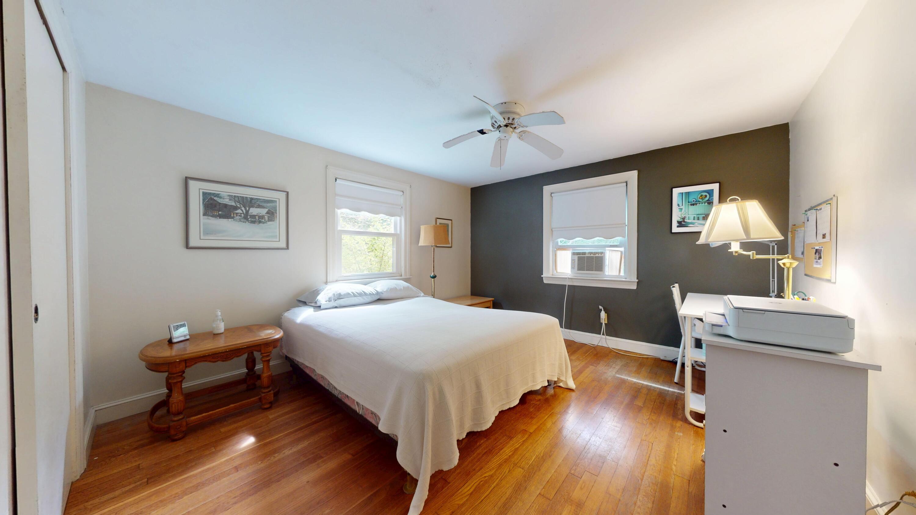 55 Monument View Road East Dennis, MA 02660 - Photo 19 of 40 a bedroom with a bed and wooden floor