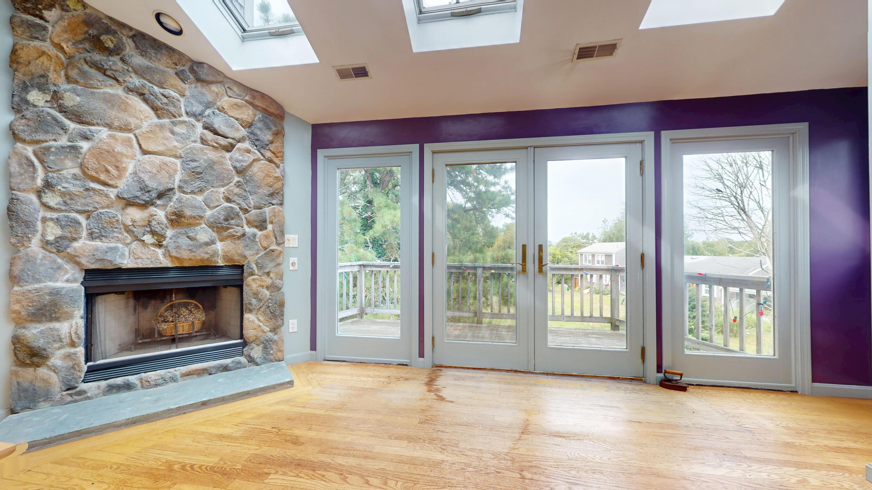 55 Monument View Road East Dennis, MA 02660 - Photo 24 of 40 a view of empty room with wooden floor and fireplace