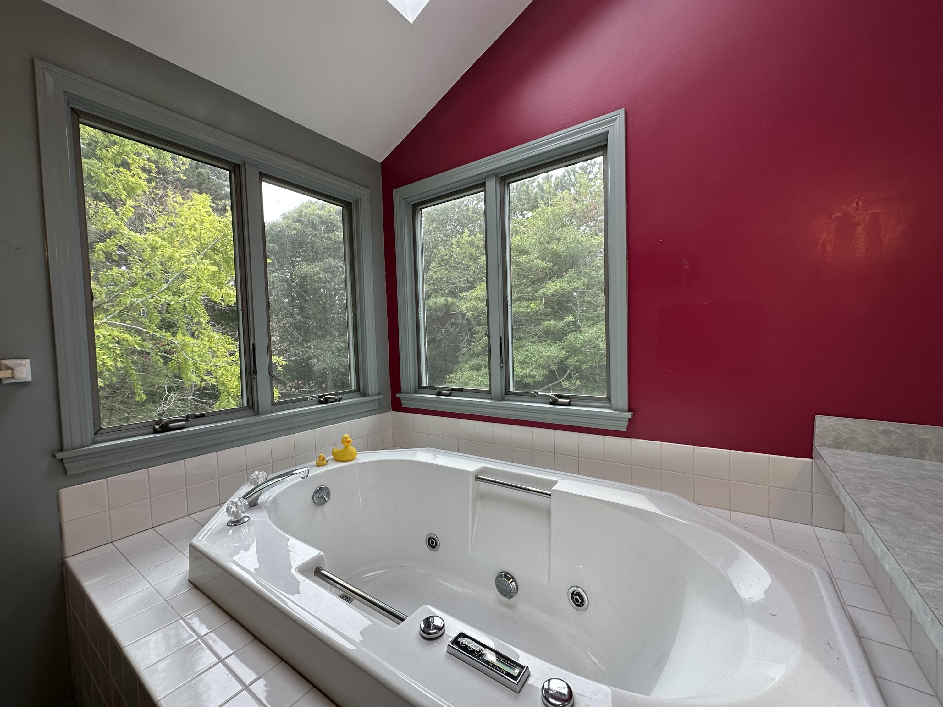 55 Monument View Road East Dennis, MA 02660 - Photo 28 of 40 a bathroom with a tub and a large window
