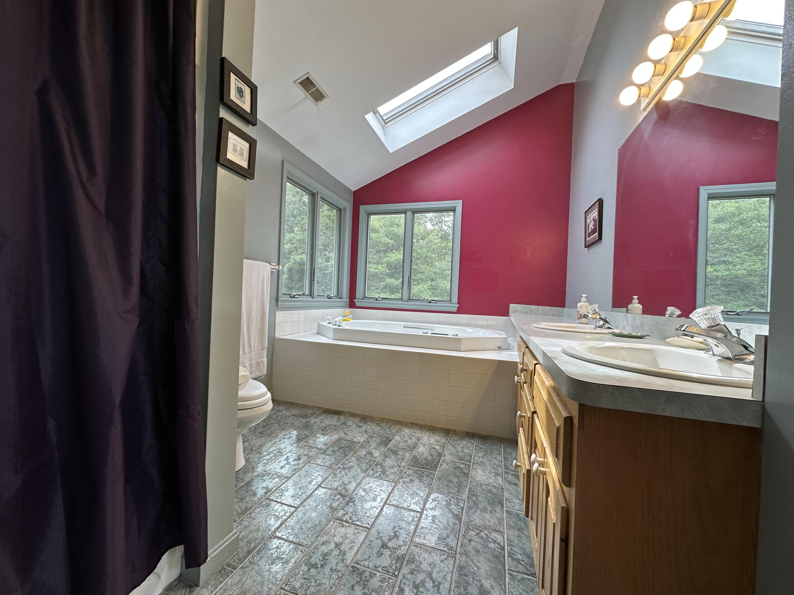 55 Monument View Road East Dennis, MA 02660 - Photo 30 of 40 a bathroom with a tub sink and mirror