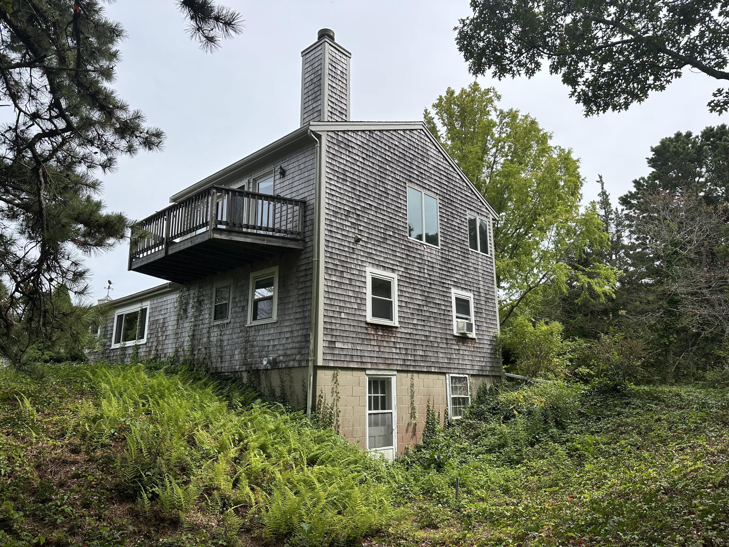 55 Monument View Road East Dennis, MA 02660 - Photo 35 of 40 a front view of a house with a yard and trees