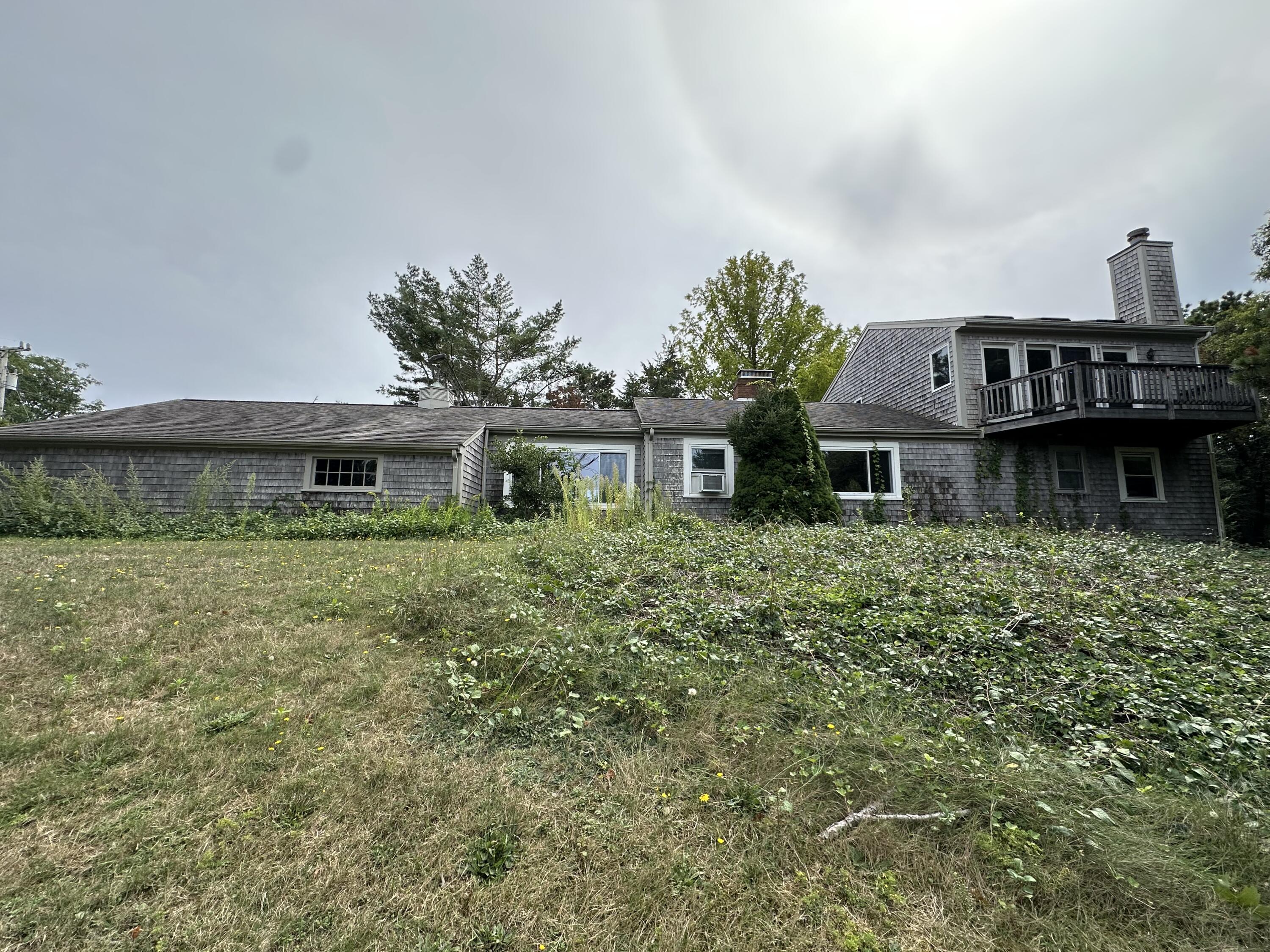55 Monument View Road East Dennis, MA 02660 - Photo 36 of 40 a front view of a house with a garden