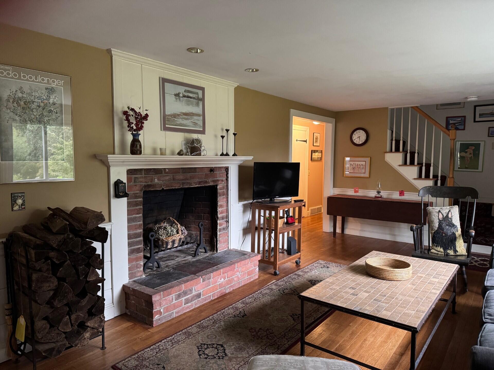 55 Monument View Road East Dennis, MA 02660 - Photo 4 of 40 a living room with furniture and a fireplace