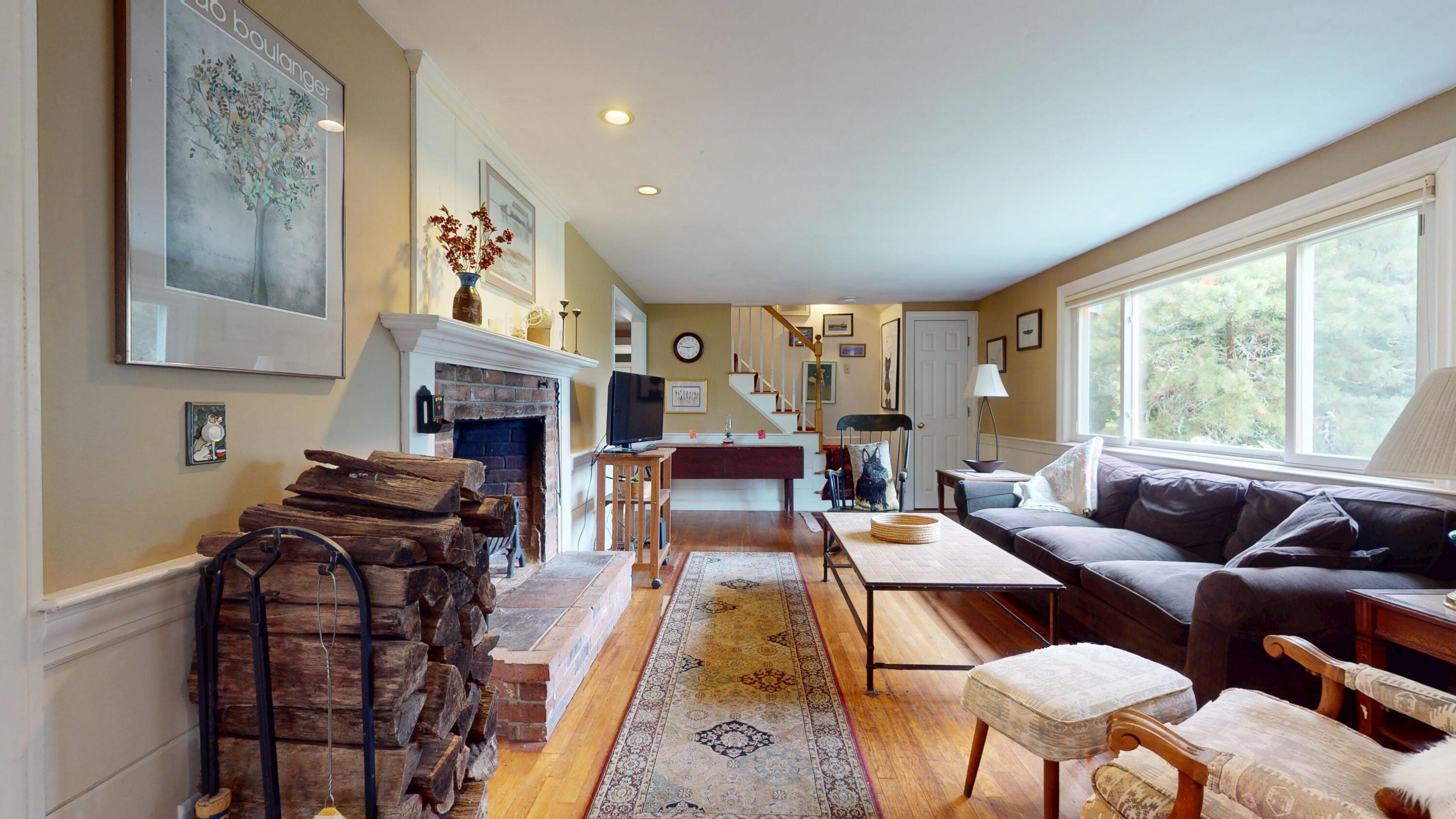 55 Monument View Road East Dennis, MA 02660 - Photo 7 of 40 a living room with furniture fireplace and a large window