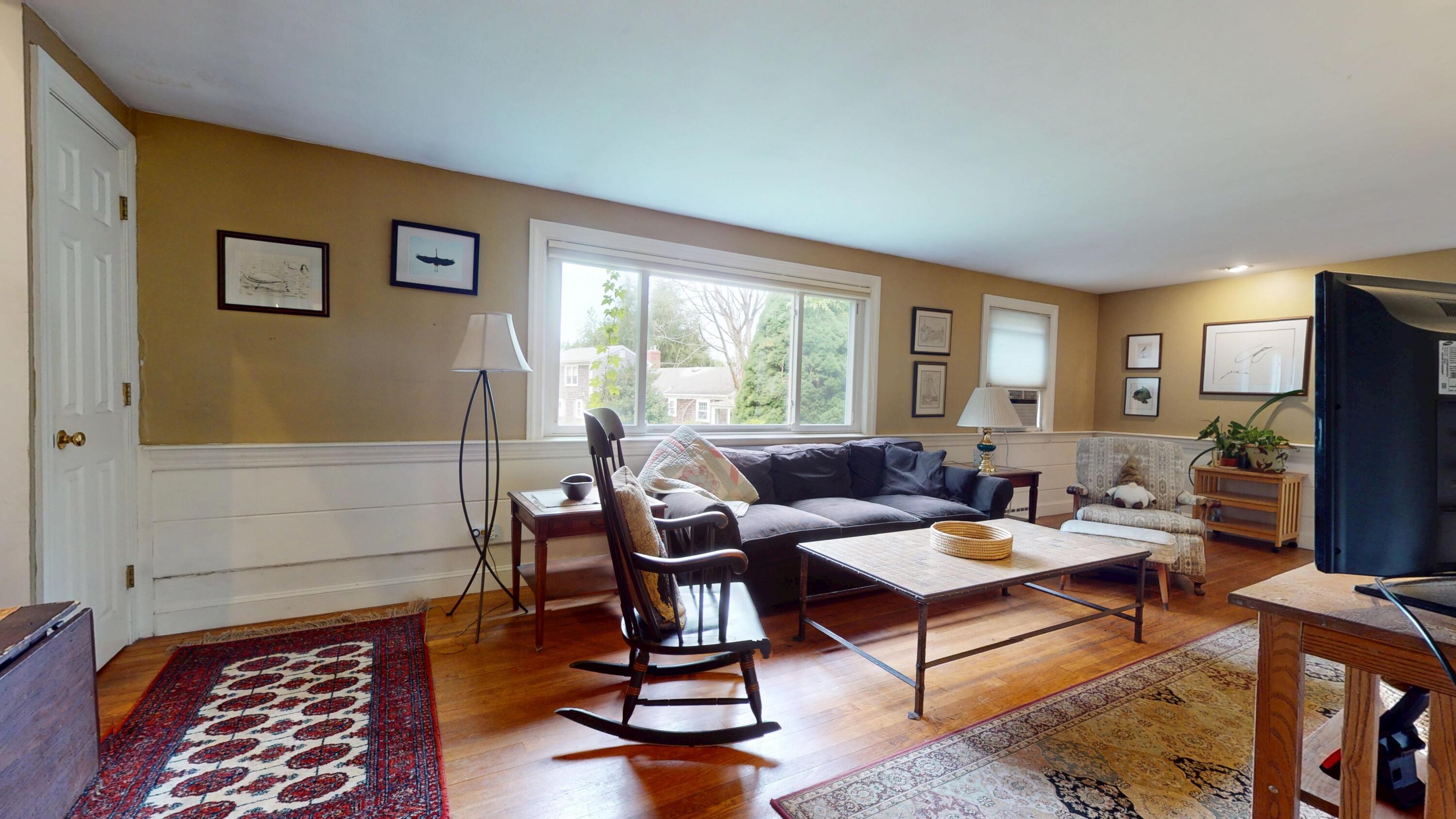 55 Monument View Road East Dennis, MA 02660 - Photo 8 of 40 a living room with furniture and a flat screen tv