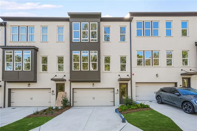 a front view of a building with a garden