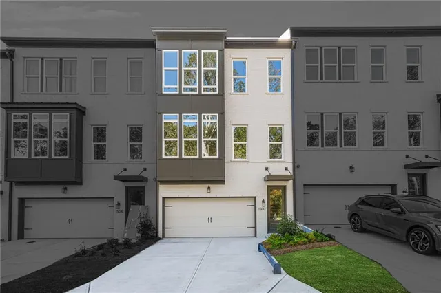 a front view of a building with a garden