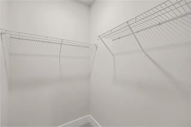 an empty room with cabinet and mirrors