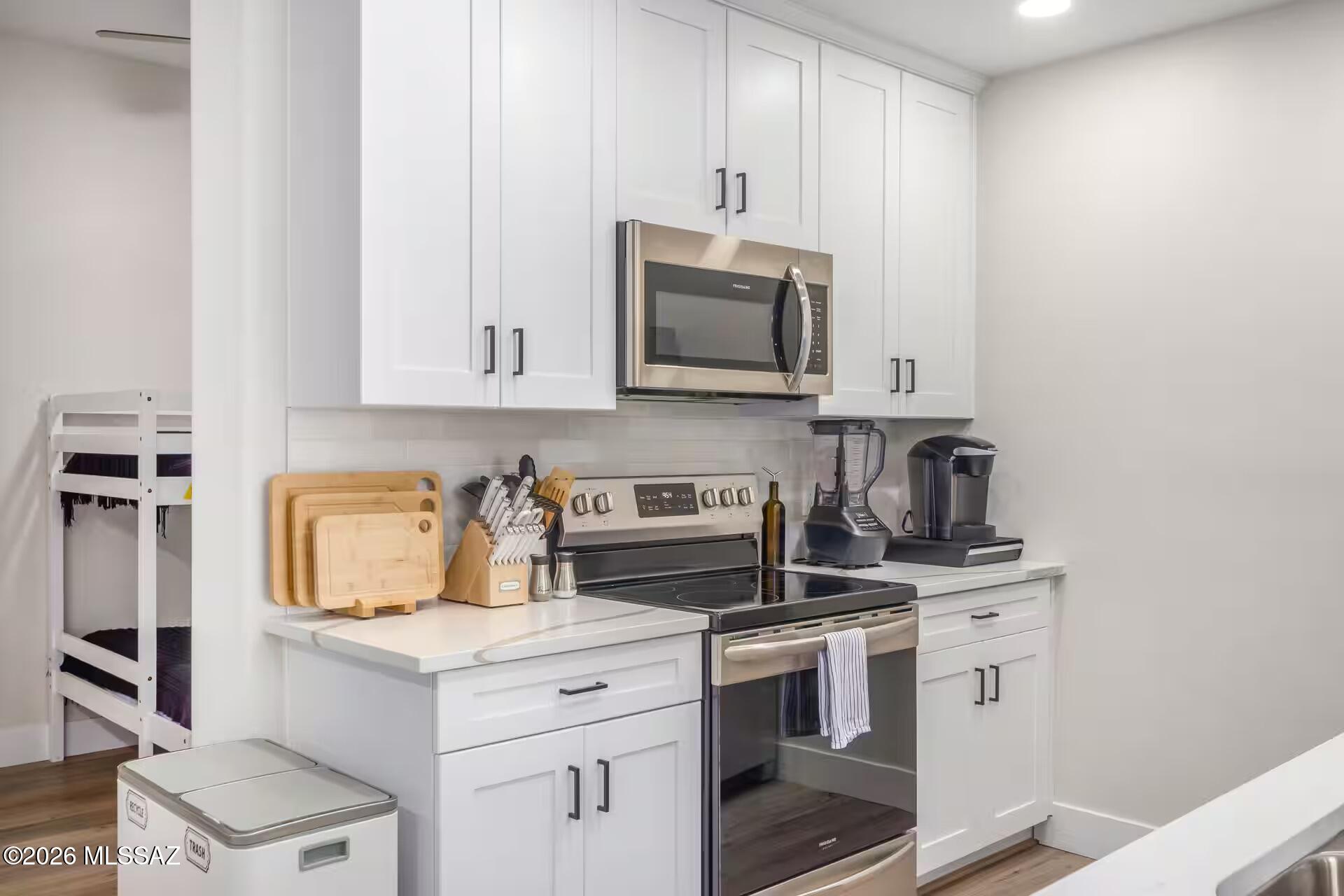 2036 East River Road, Unit 104 Tucson, AZ 85718 - Photo 5 of 23 a kitchen with appliances a sink and cabinets
