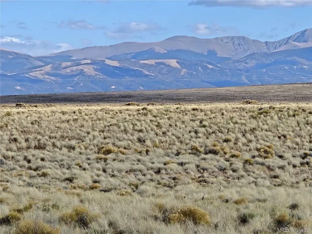 a view of a yard with mountains in the background