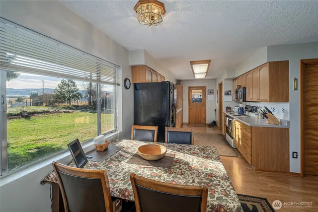 a kitchen with a table chairs stove and refrigerator