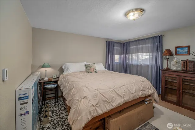 a bedroom with a bed and dresser