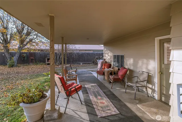 a view of a patio with a dining table and chairs