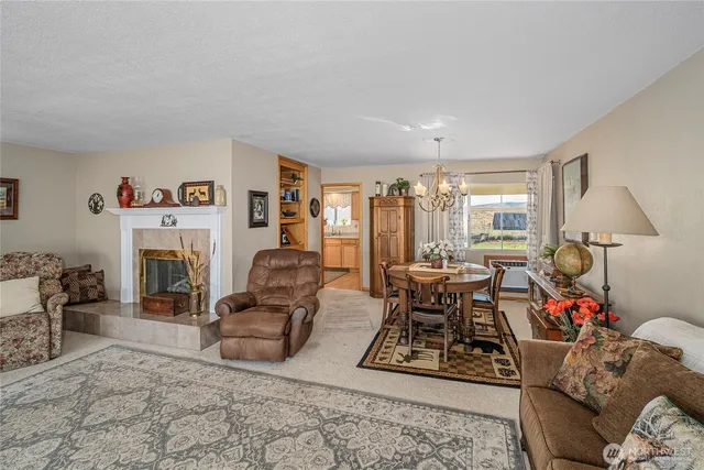 a living room with furniture a fireplace and a table with a fireplace