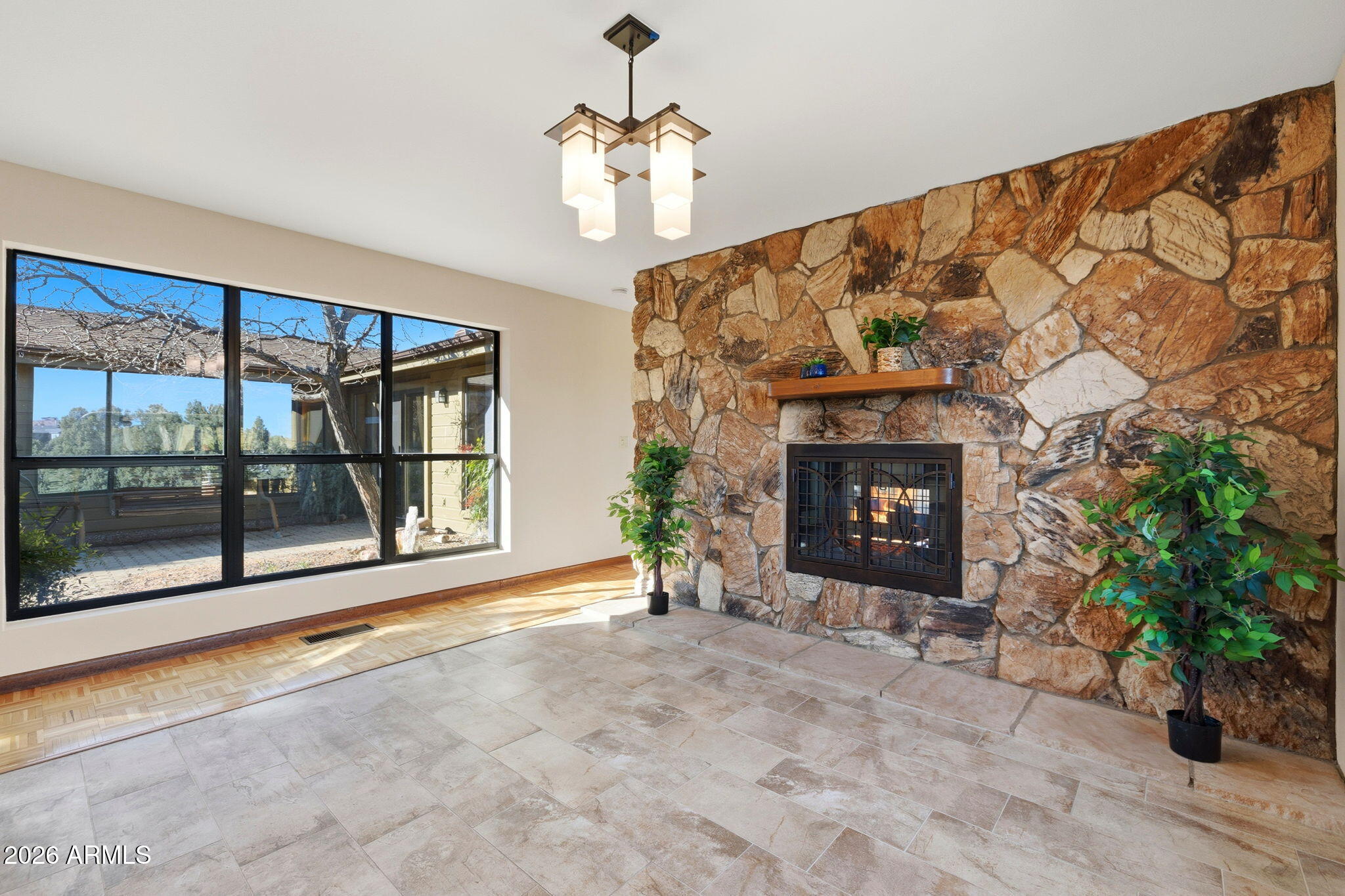 220 High Chaparral Loop Prescott, AZ 86303 - Photo 13 of 42 a view of an empty room with a fireplace and potted plant