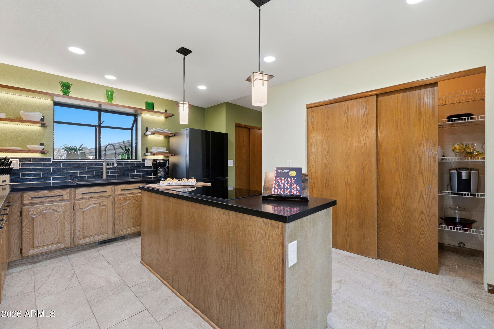220 High Chaparral Loop Prescott, AZ 86303 - Photo 16 of 42 a kitchen with stainless steel appliances kitchen island granite countertop a sink and a refrigerator