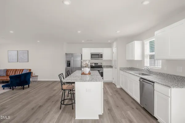 a large kitchen with a table and chairs in it