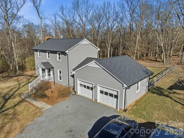 a aerial view of a house with a yard and balcony