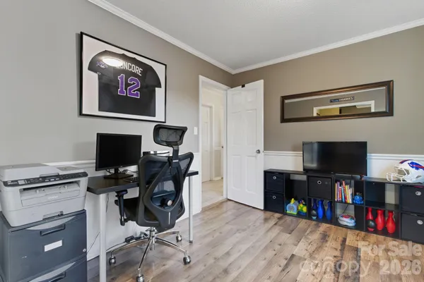 a view of a workspace with furniture and a flat screen tv