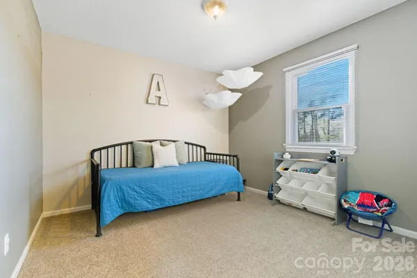 a bedroom with furniture and a window